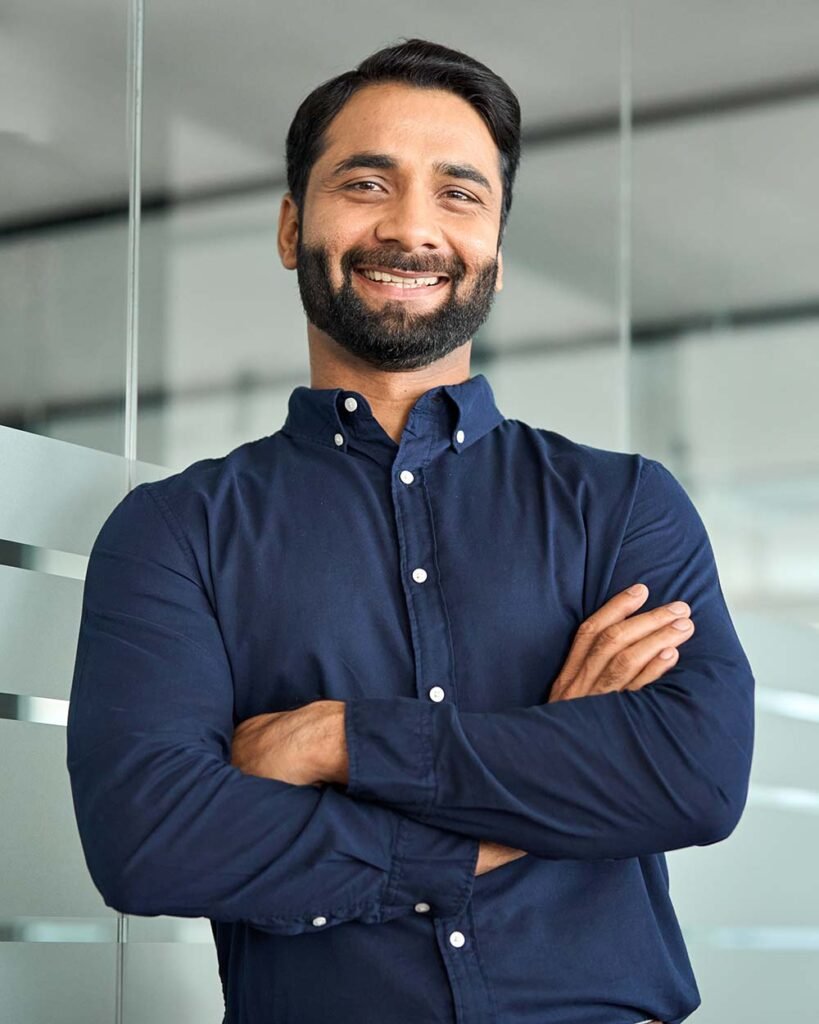 happy confident indian businessman standing in off dcxp57r.jpg