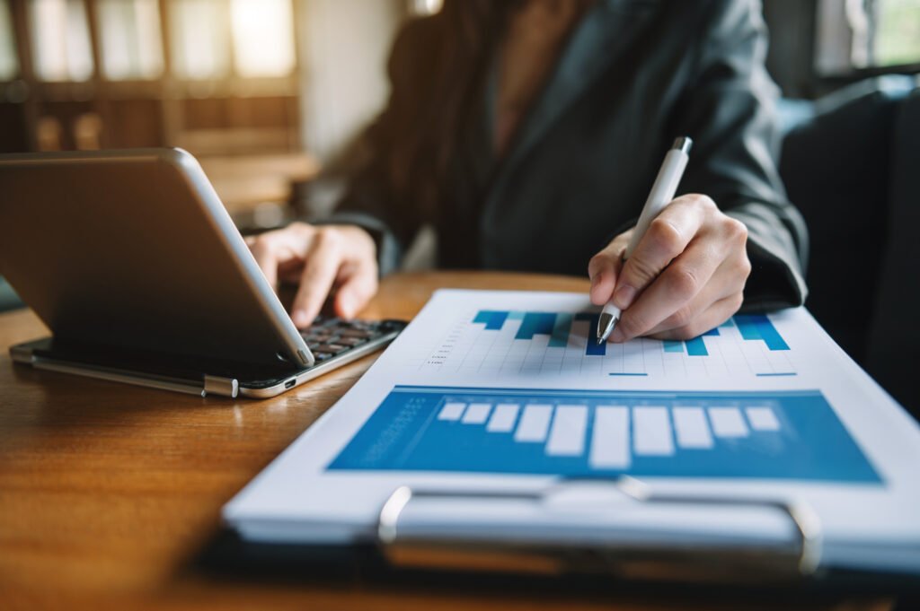 women counting coins on calculator taking from the piggy bank.